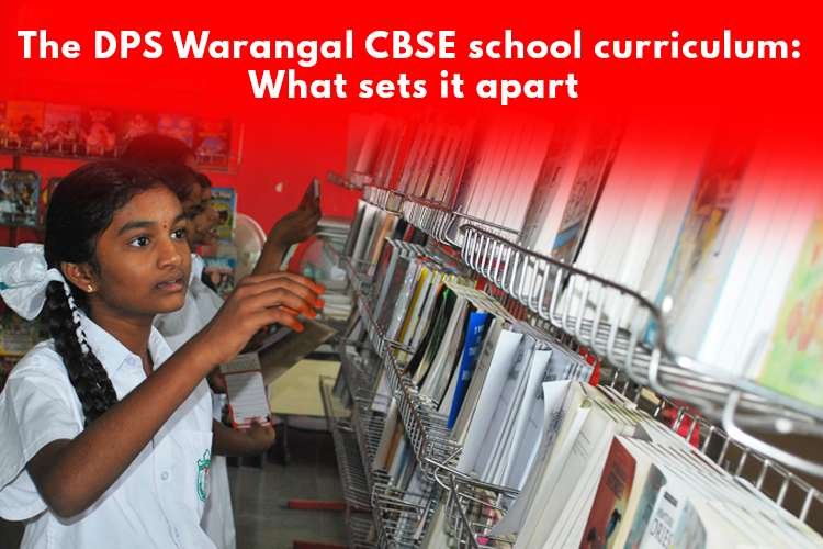 Girls in white uniforms engage in focused activities in a library setting. Some hold books, others look straight ahead. Text at the top: 'The DPS Warangal CBSE school curriculum: What sets it apart?'