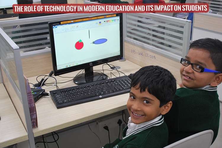 two young boys sitting in front of a computer understanding the role of technology