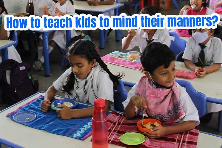 A group of children eating in a classroom and learning manners