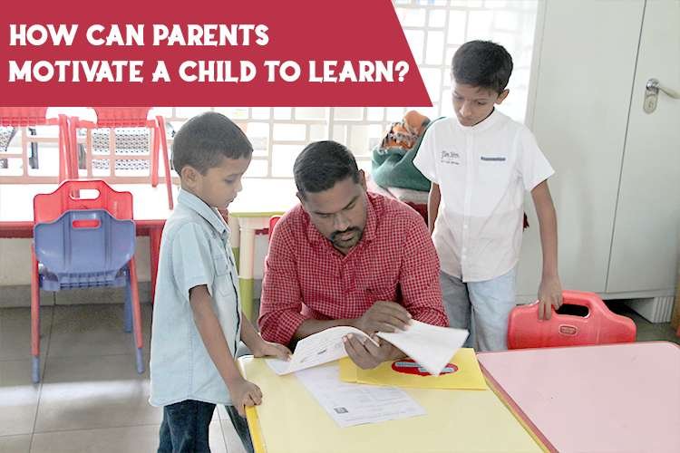 A teacher sits on a chair, engaging students, encouraging and motivating them to learn