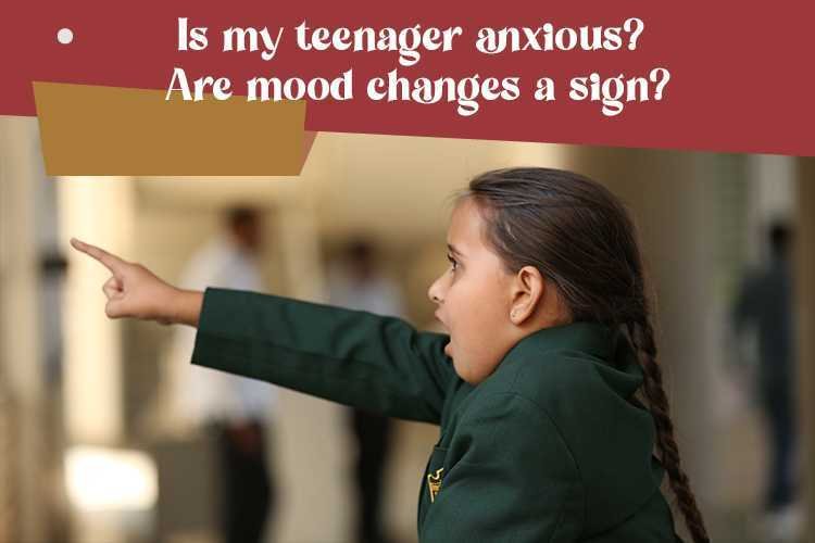 Anxious young child pointing with concern and curiosity towards something out of frame.