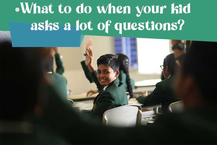 A child raising his hand in a classroom to ask questions