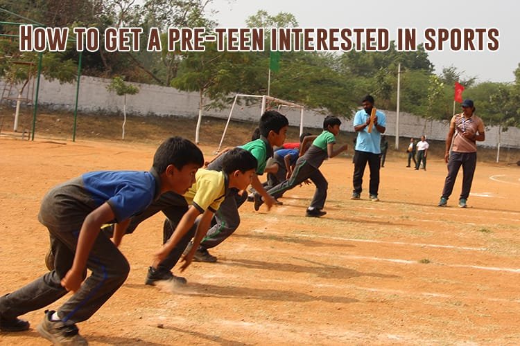 A group of young boys running on a sports field.