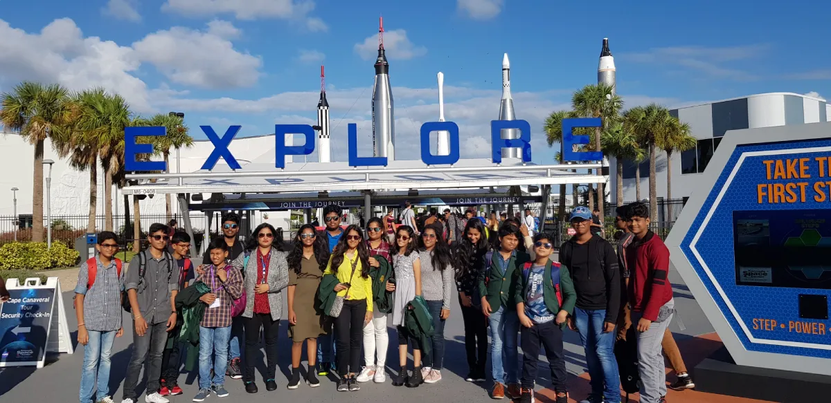 Students standing under the Explore title went on an international trip.