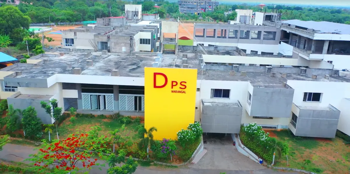 DPS Warangal school building with the school name on the building with a greenery around the building.