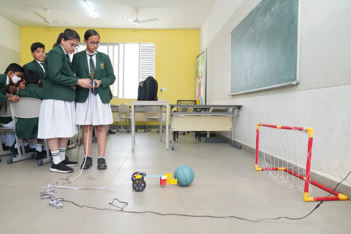 Two girls of DPS Warangal, testing the robotics experiment in the class.