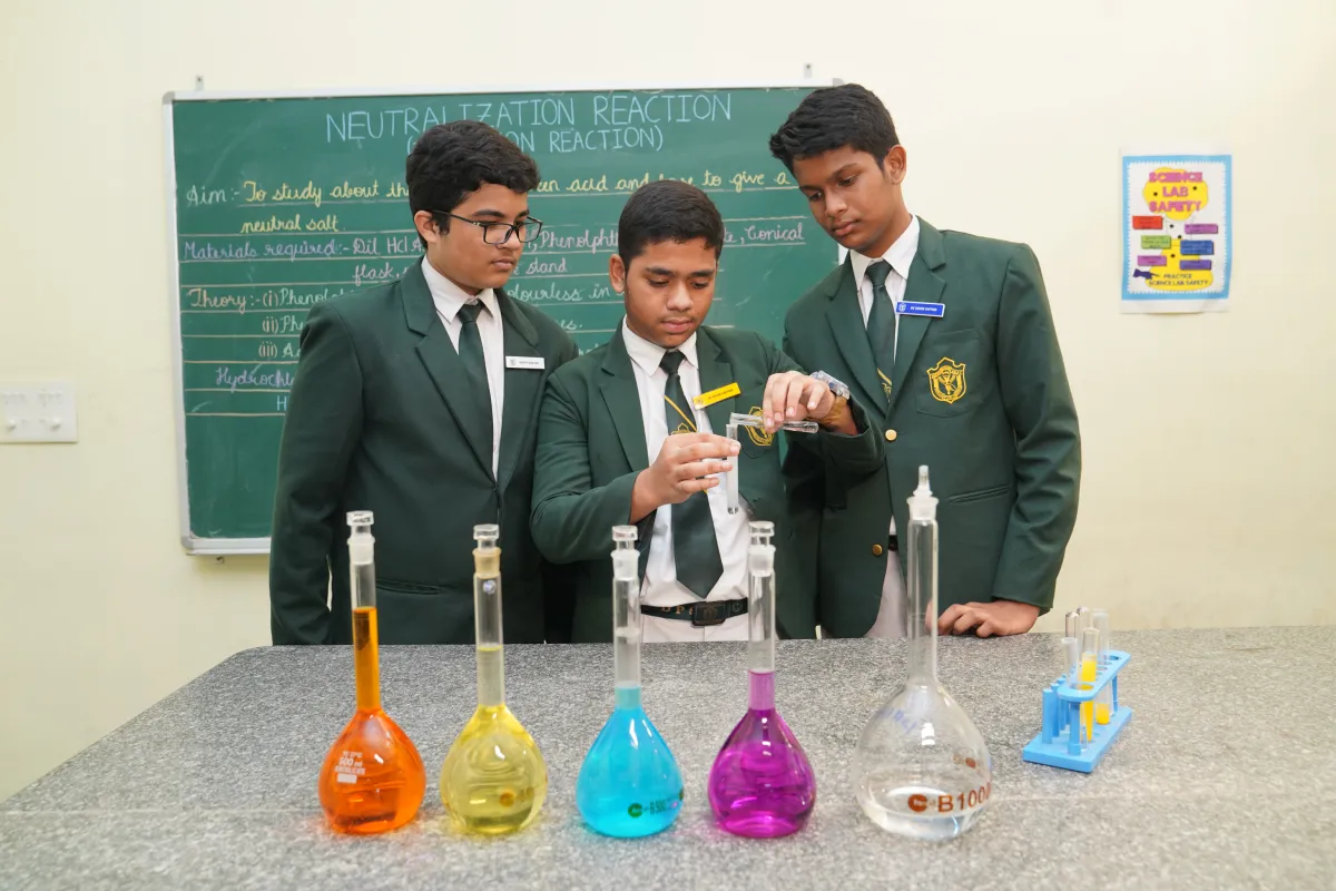 Students performing science experiments in a sizeable chemistry laboratory.