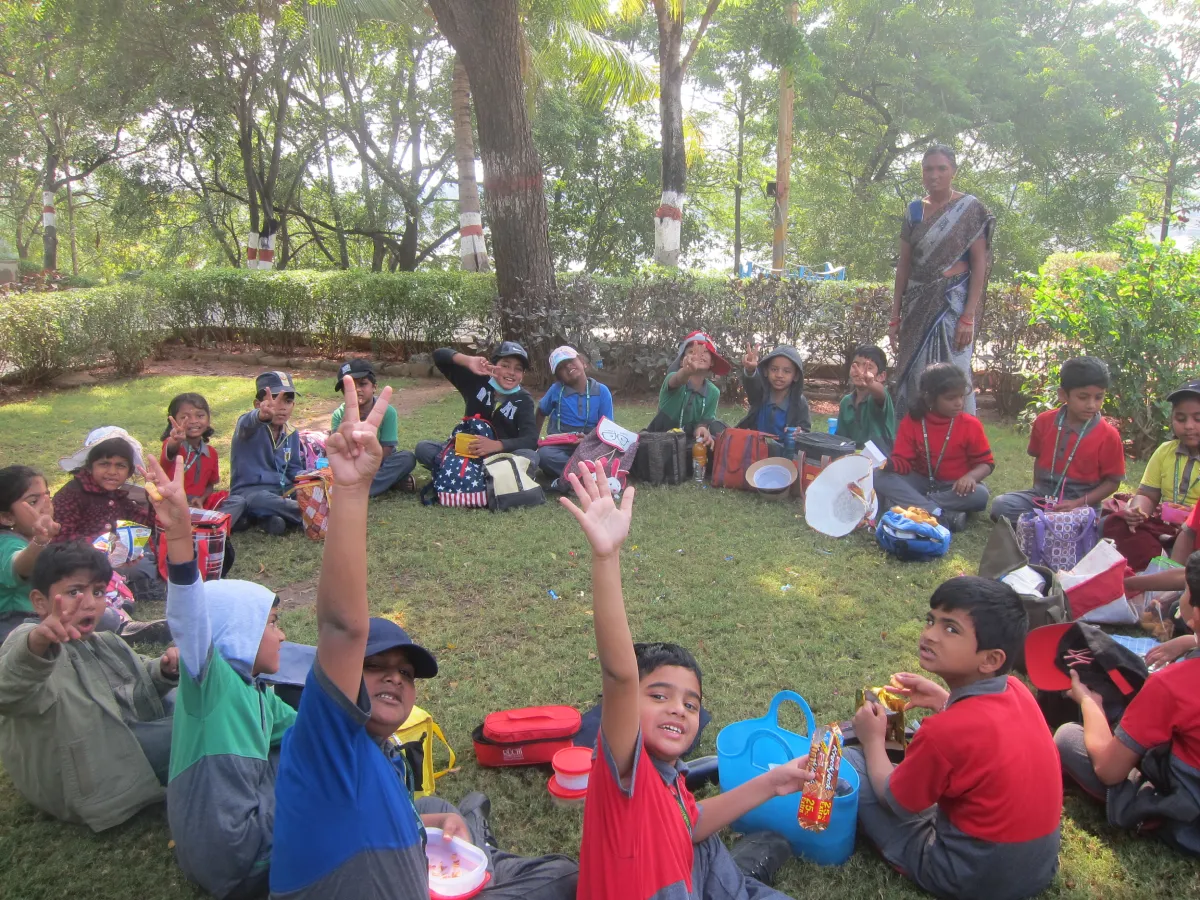 Kids along with their friends and teachers enjoying a picnic day at school