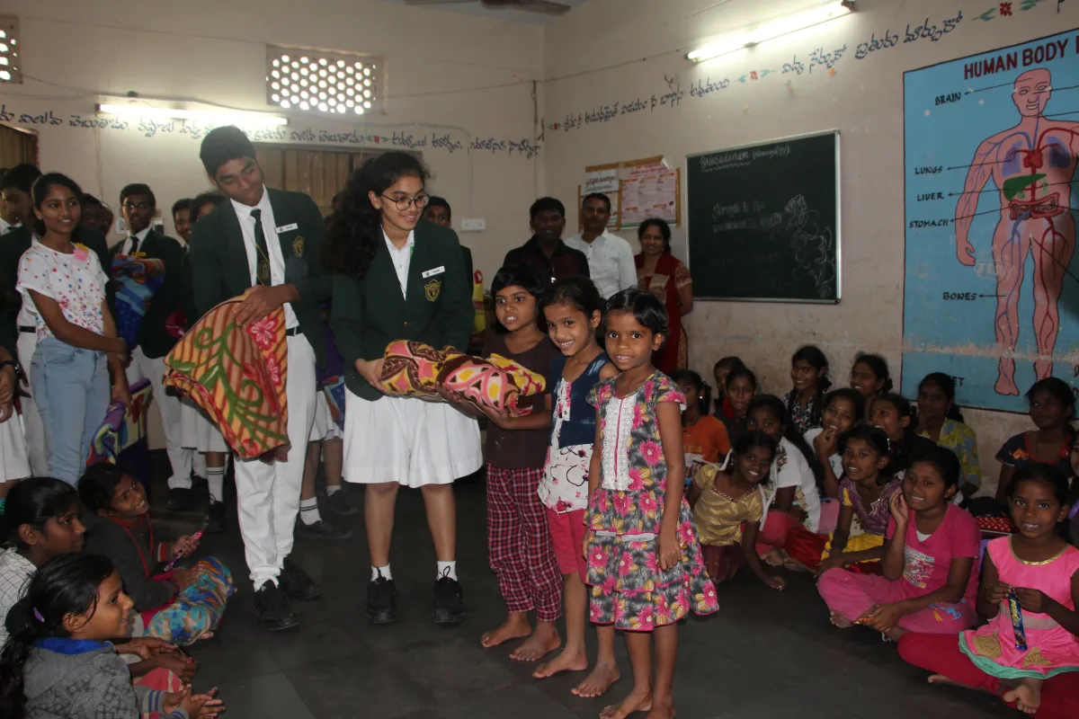 Students of DPS Warangal donating blankets to poor children and bringing smiles on their faces.