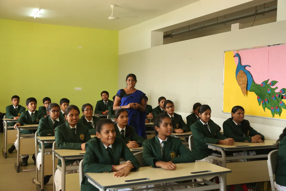 Teacher giving lecture in the classroom filled with enthusiastic students at DPS, Warangal