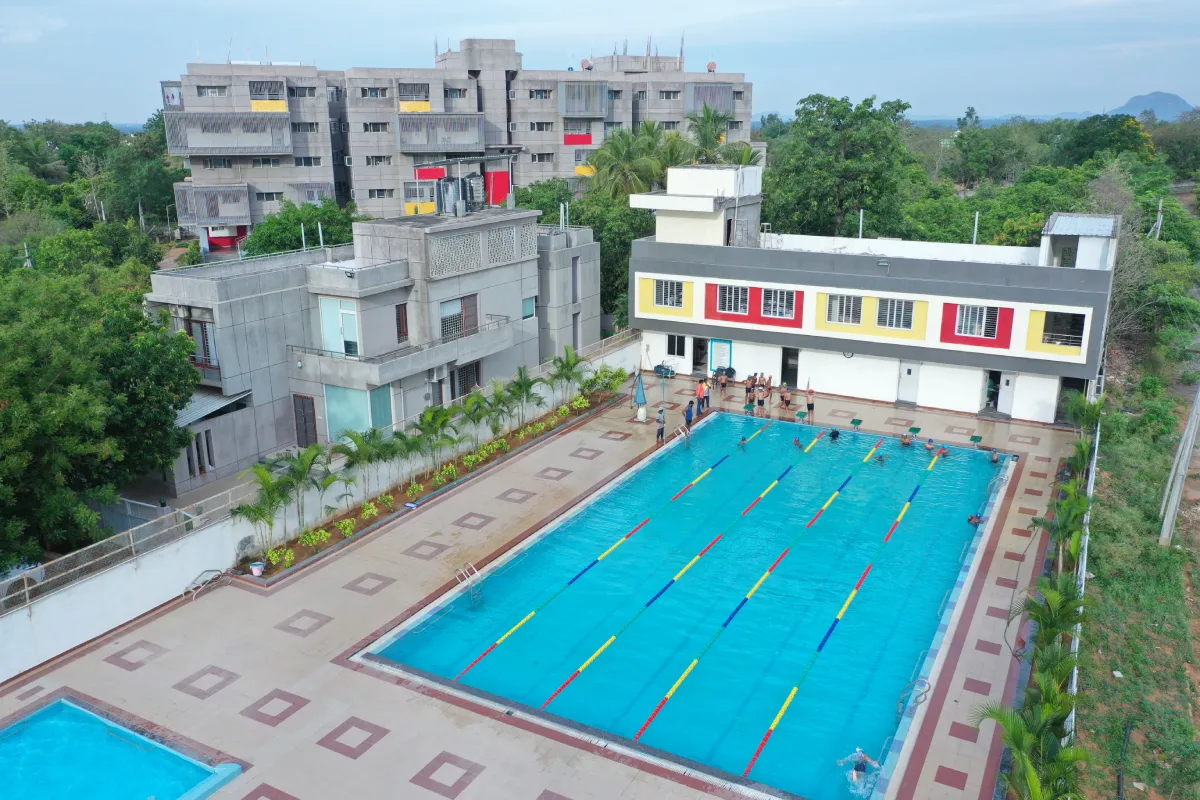 DPS Warangal students standing beside the school swimming pool and hostel premises as seen in an eagle-eye view.