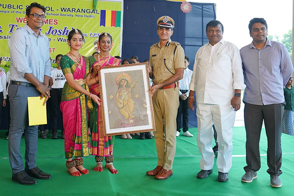 DPS Warangal gifted a Saraswati Maa painting to the police officer on the stage.