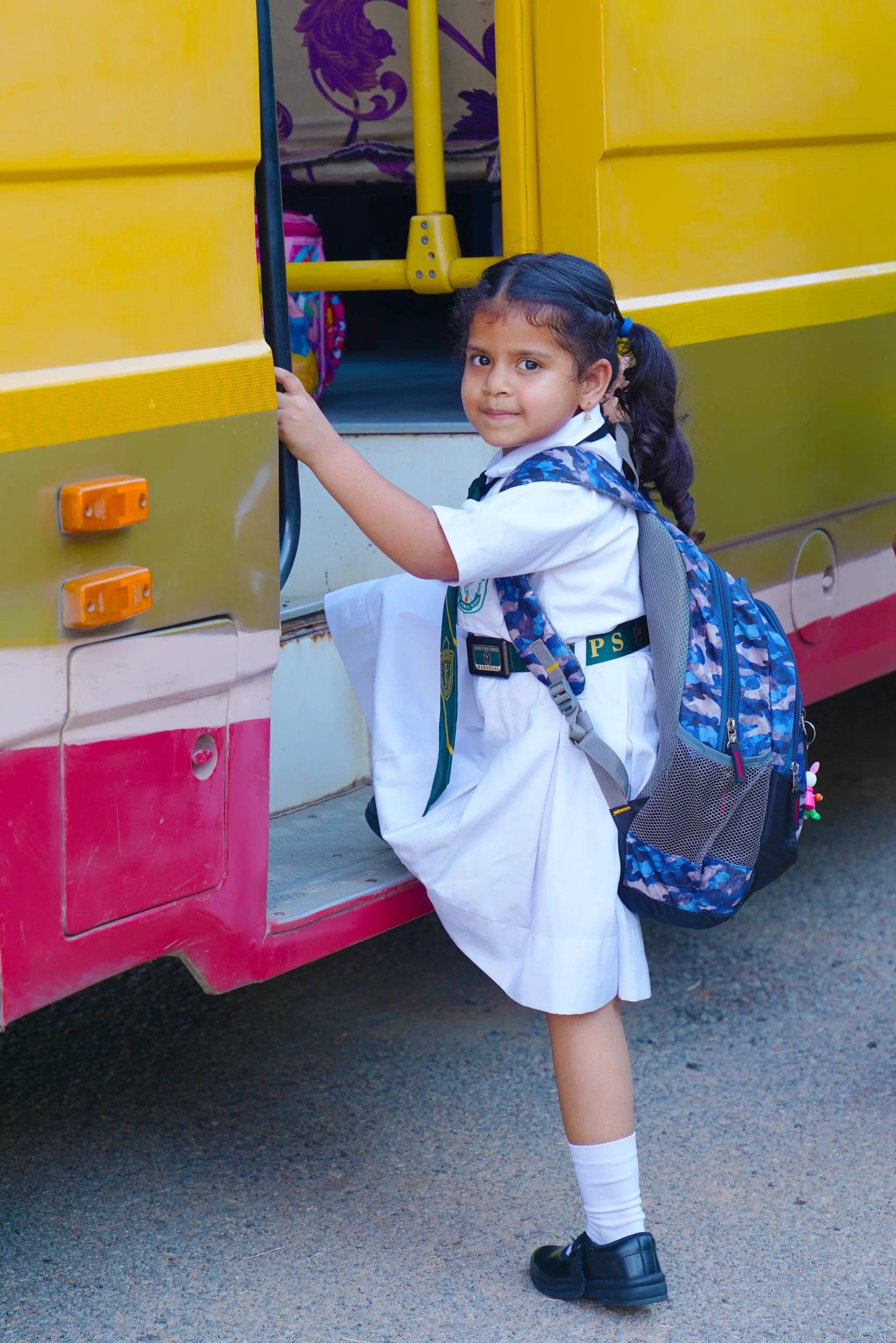 One small girl getting into the school bus at DPS Warangal.