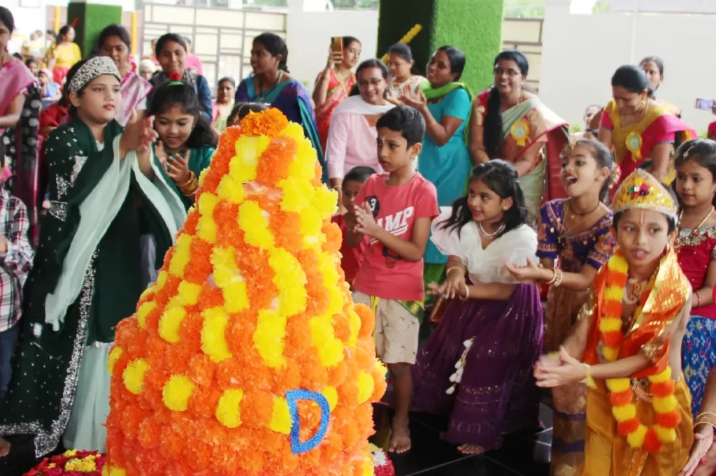 Students and teachers at DPS, Hanamkonda, Warangal celebrating Krishna Janmashtami by wearing traditional clothes and decorating matki with flowers.