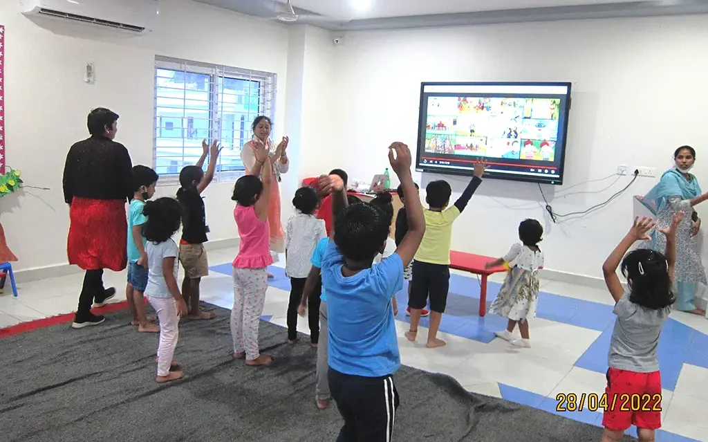 Children practicing dance with the teacher in the dance room.
