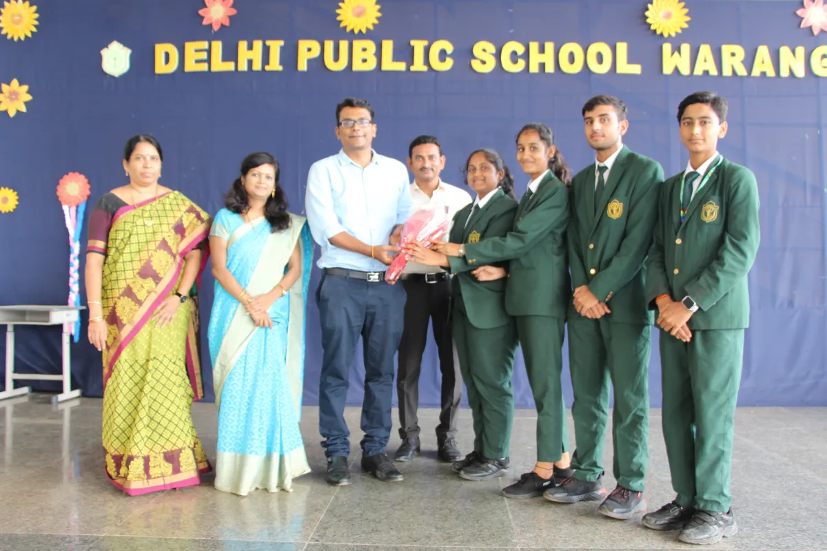 Students presenting flower bouquet to Chief Guest in Delhi Public School, Warangal.