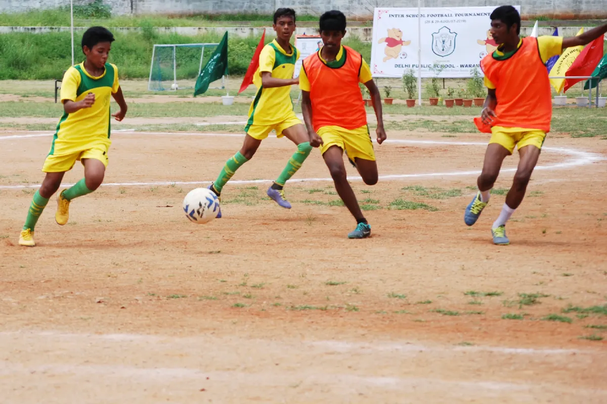 DPS Warangal students playing football on the football court.