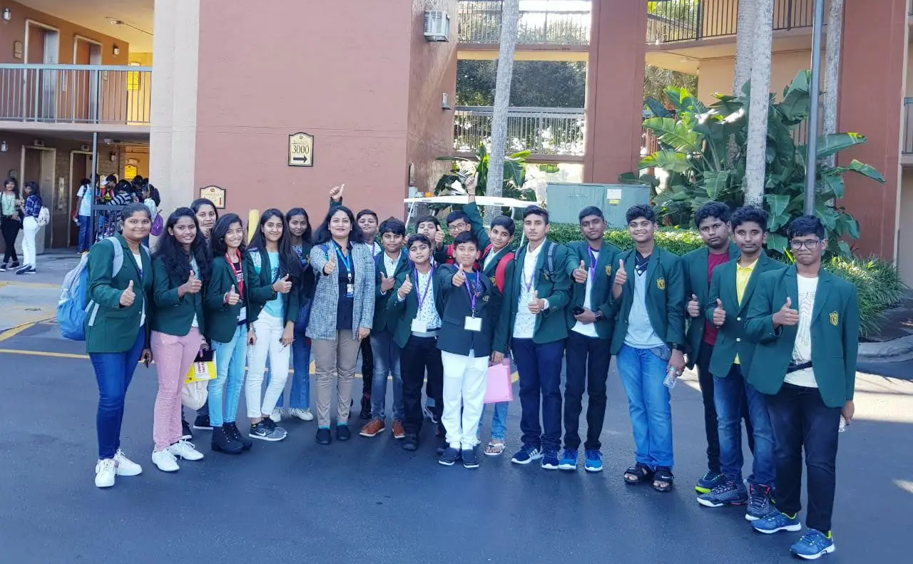 Students of DPS, Warangal standing in group and getting clicked together during visit to NASA.