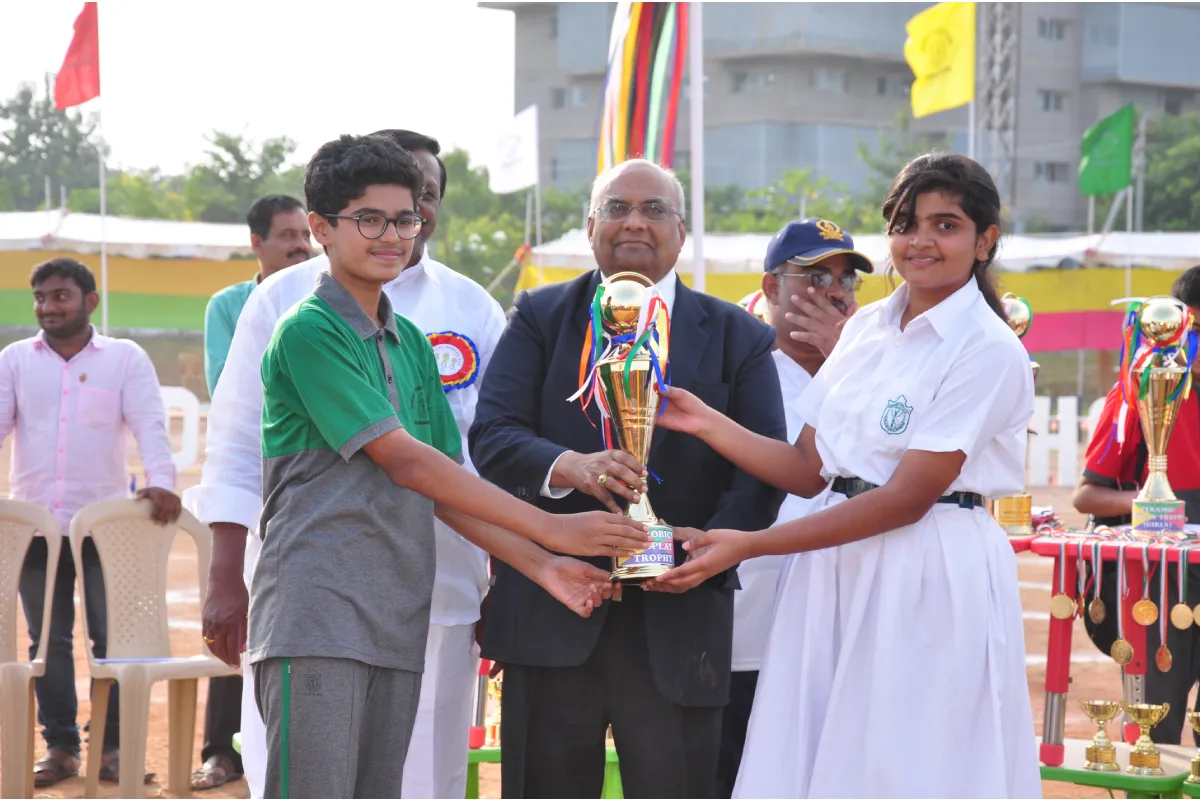 Chief Guest distributing trophy to the students who are winners in Sports Day celebration at DPS, Warangal.