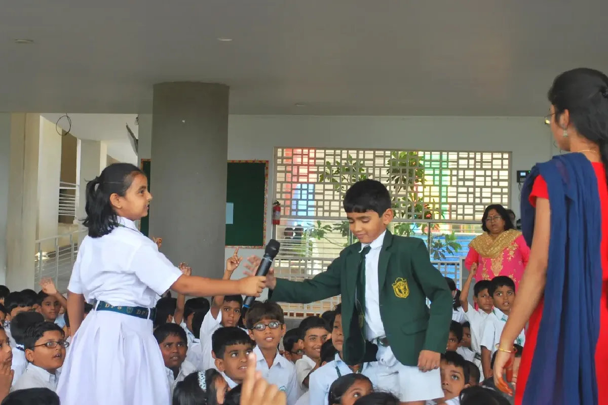 Student of DPS, Hanamkonda passing mic to other student after completing her chance of speaking during a class discussion.