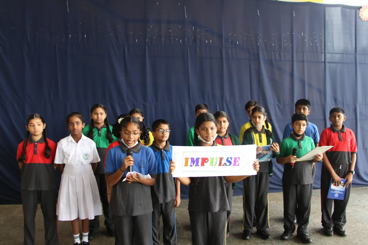 DPS Warangal students standing with mic in hand and learning about ene English words.