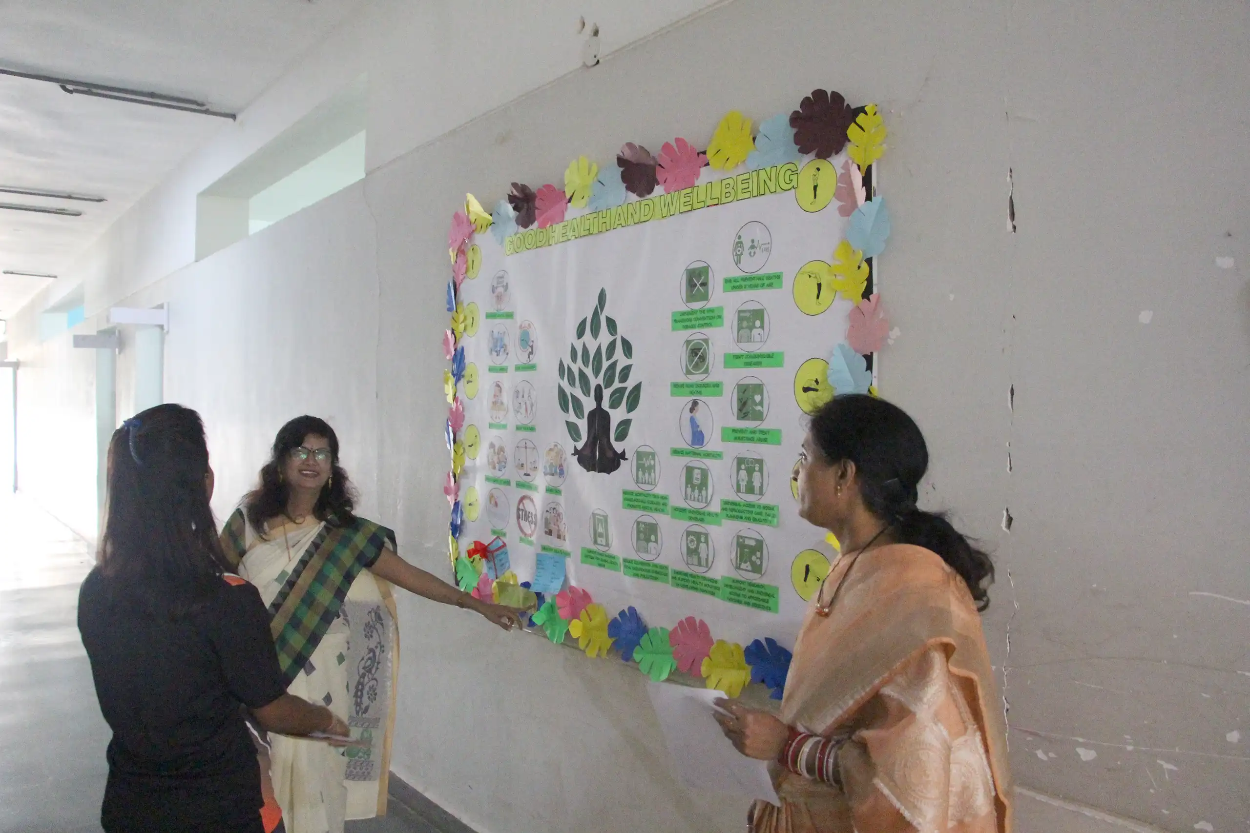 Teachers at DPS Warangal checking bulletin board which students have decorated.