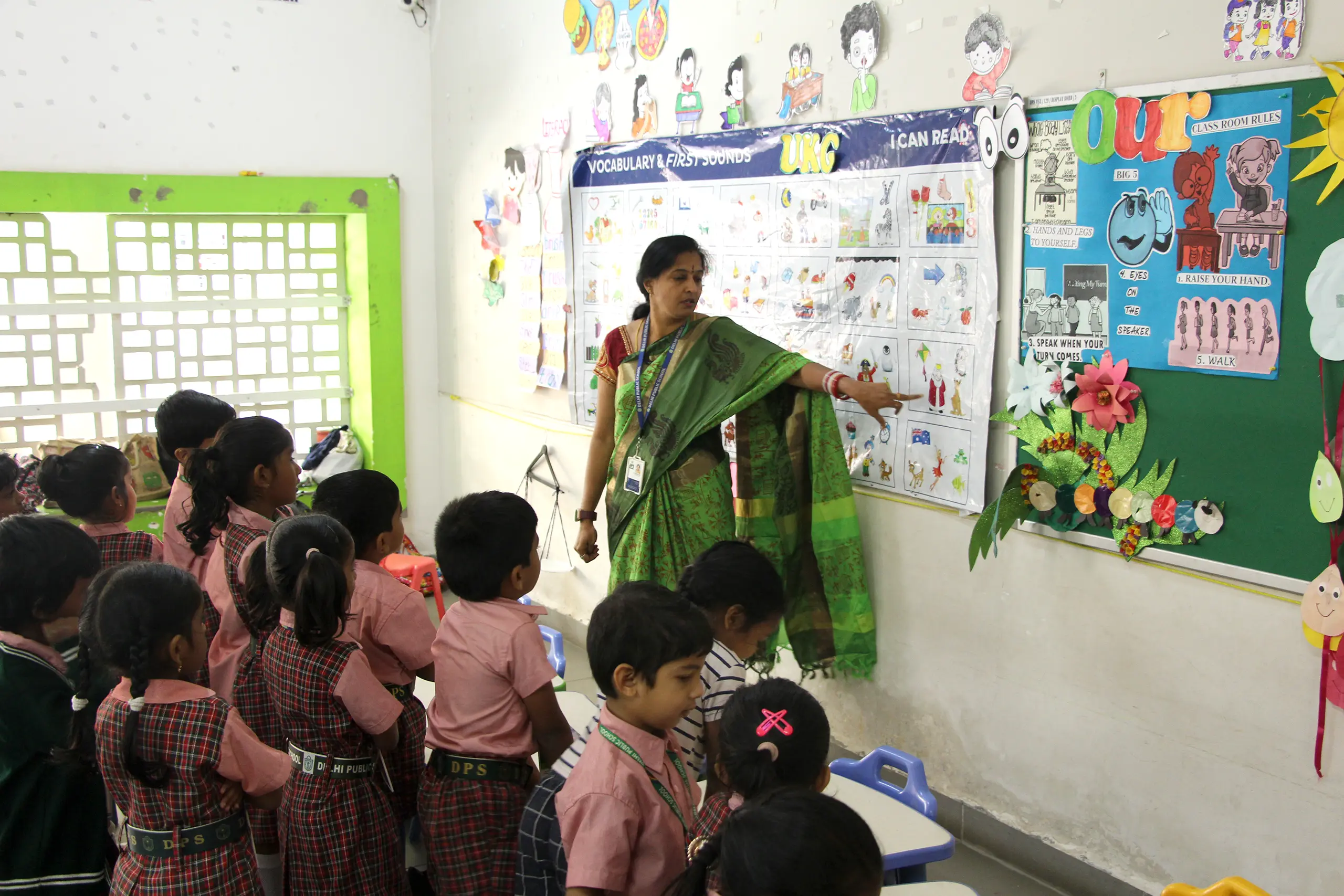 Teacher teaching vocabulary to students using charts in the class at DPS Warangal