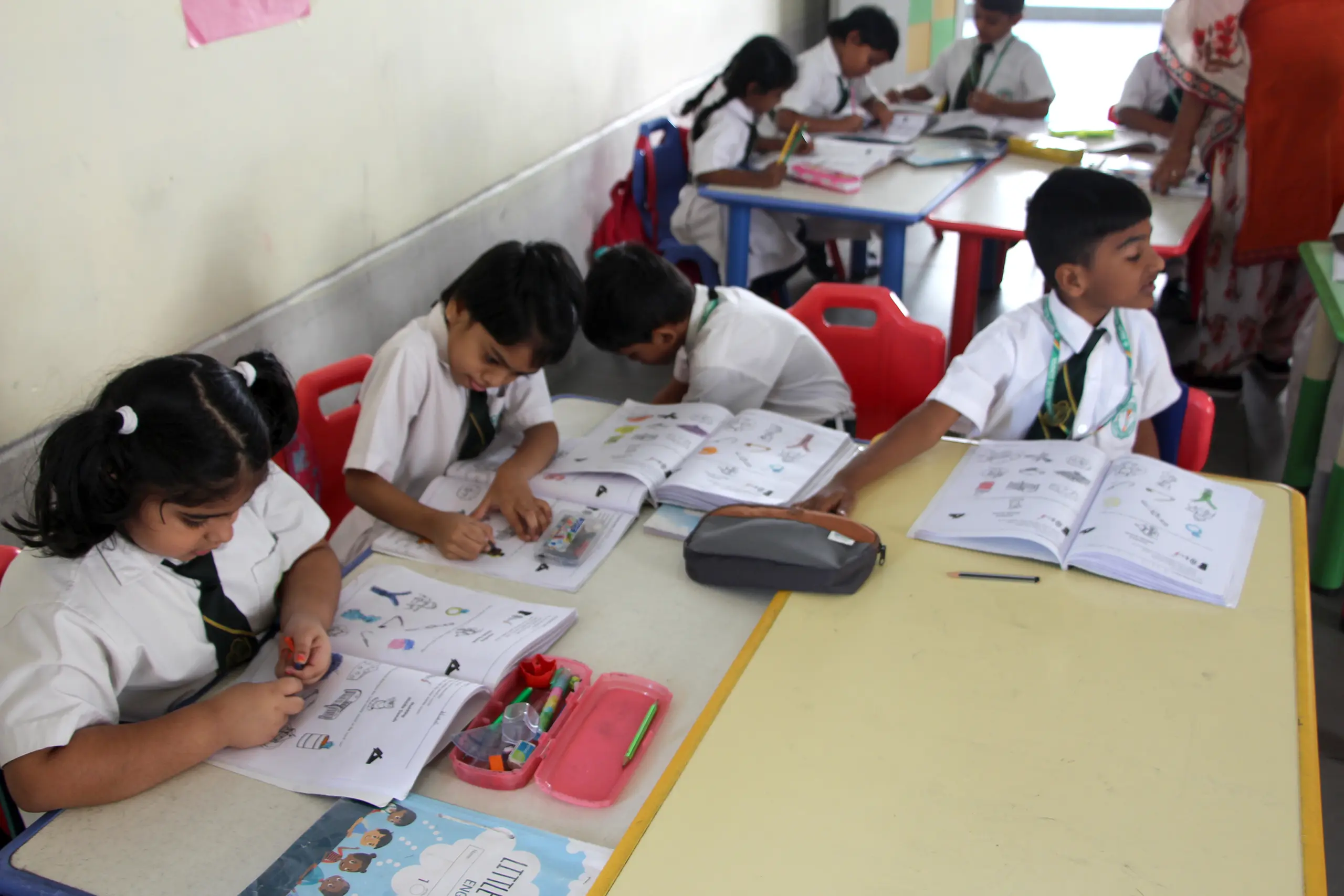 Students sitting in the class and completing their work at DPS Warangal.