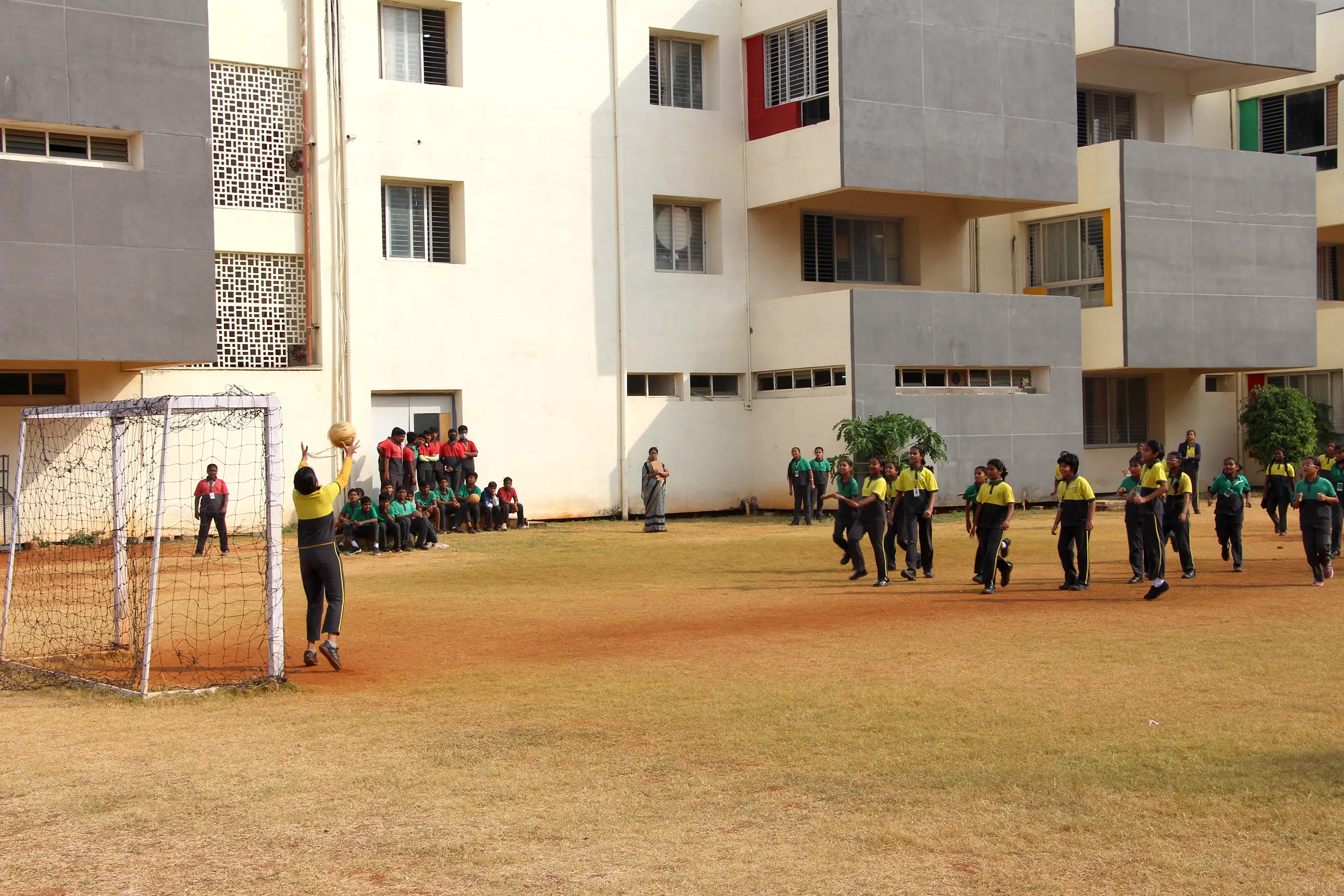 Students of DPS Warangal playing sports in the ground.