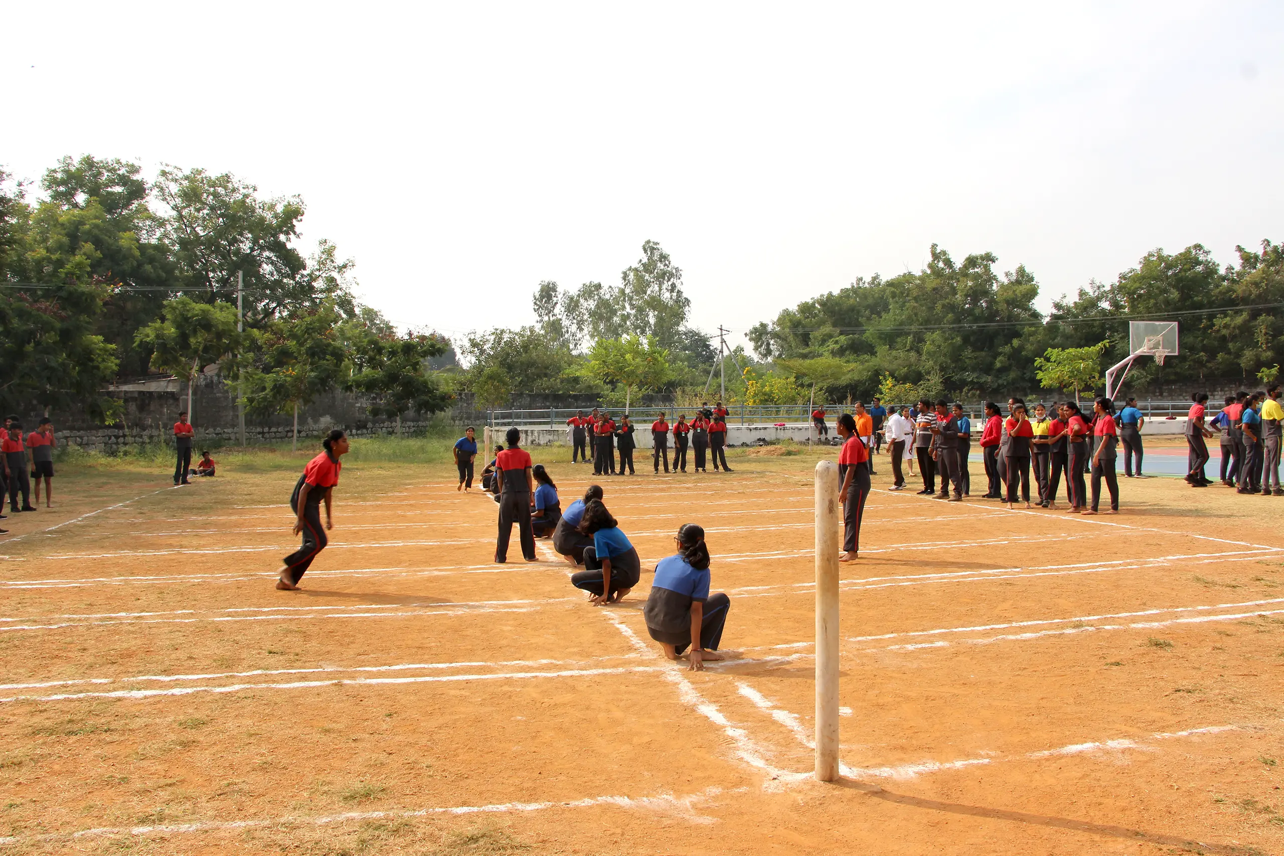 Students playing kho-kho on the ground at DPS Warangal.