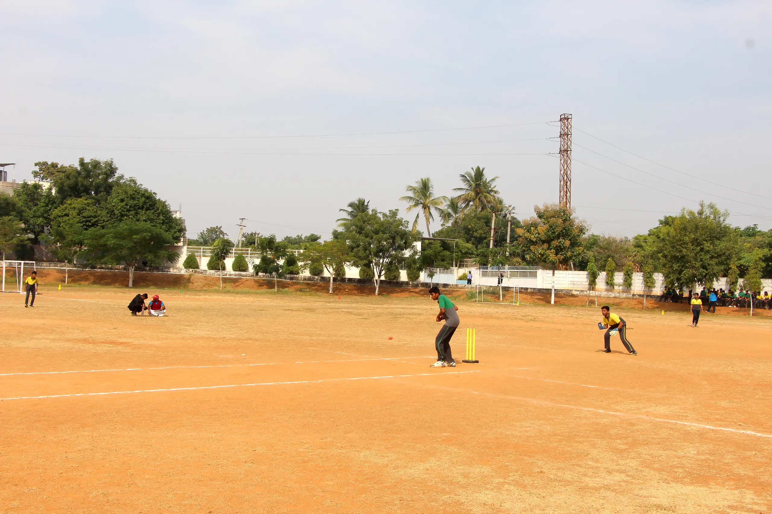 Students playing cricket on the ground at DPS Warangal.