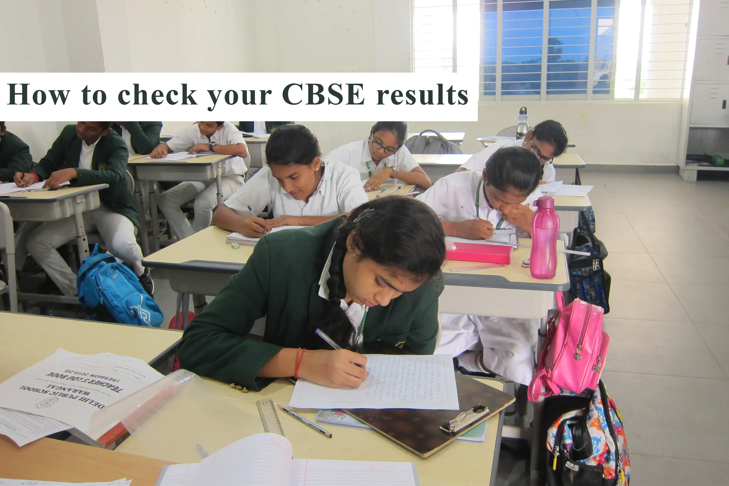 The image captures the focused atmosphere of students writing exams, accompanied by the text 'How to check your CBSE results' at the top.