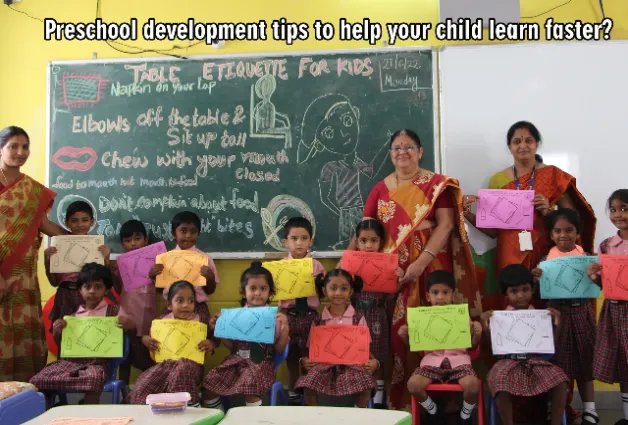 Children at DPS warangal holding colourful charts in their hands and standing beside teachers.