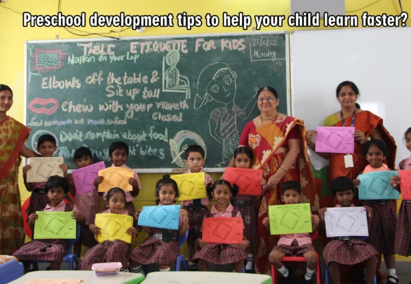 Children at DPS warangal holding colourful charts in their hands and standing beside teachers.