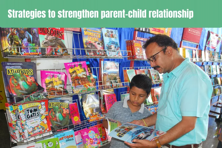 A young boy standing and choosing a book with his father, surrounded by a display of children's books. showing their strong relationship