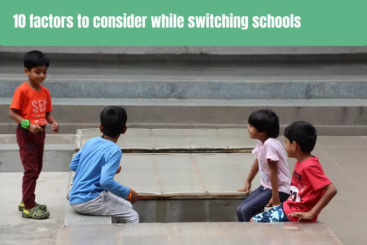 Image of four children sitting and enjoying each other's company on the ground. The text at the top of the image reads '10 factors to consider while switching schools.'