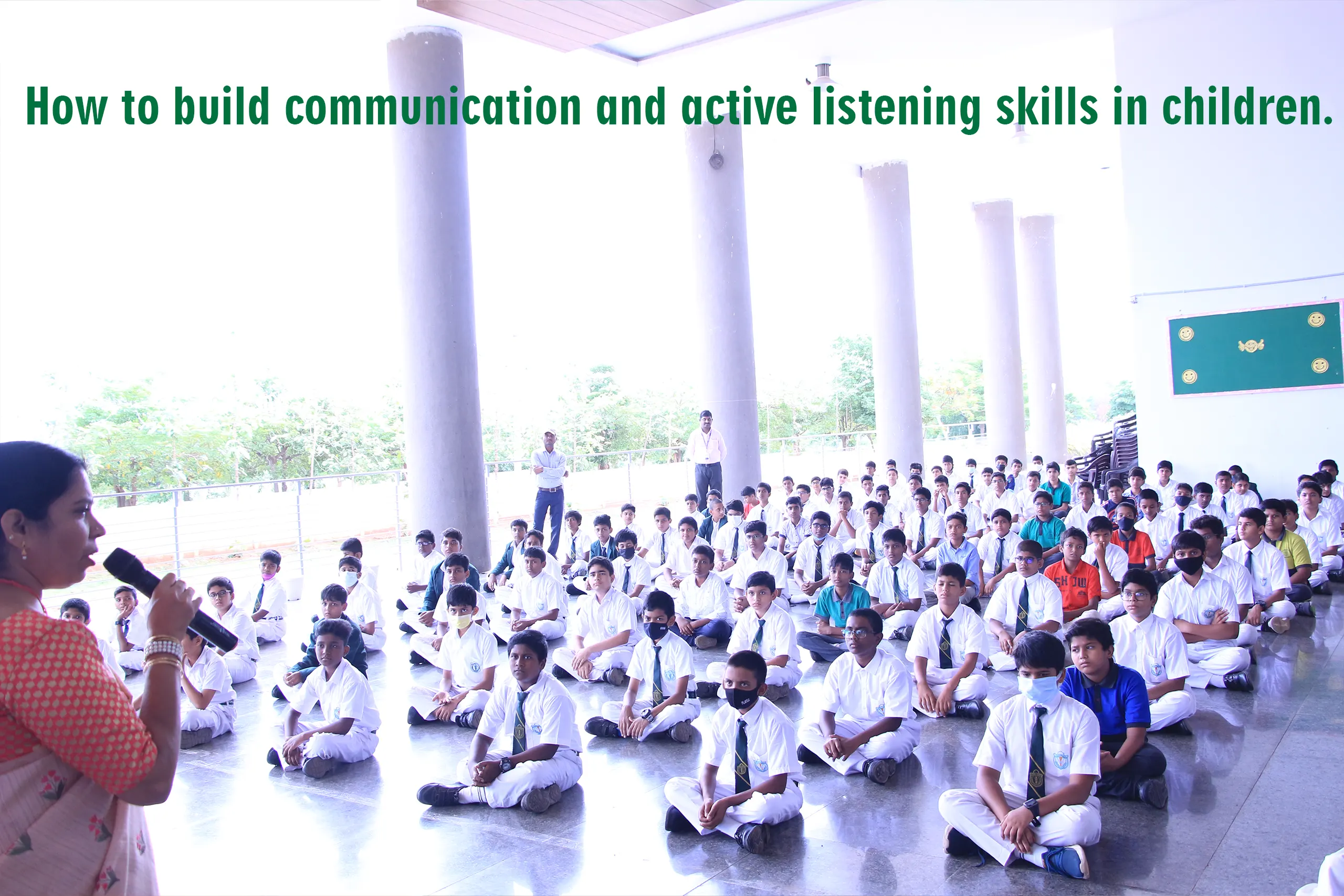 Teacher giving speech about the topic "improving skills in students" from the porch area of school.