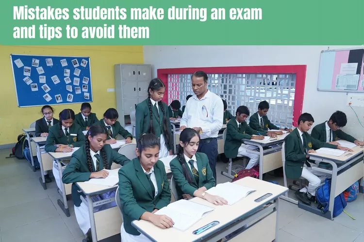 Teacher helping kid in solving their query in the exam at the classroom