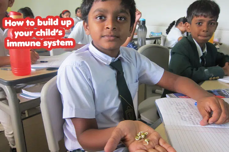 A young child holding a handful of small objects and Guide on boosting your child's immune system using the best school, DPS Warangal.