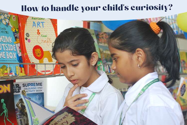A few young girls reading a book with a curiosity