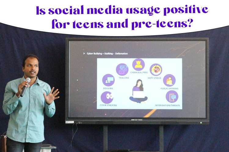 A person standing in front of a large screen talking about effects of social media