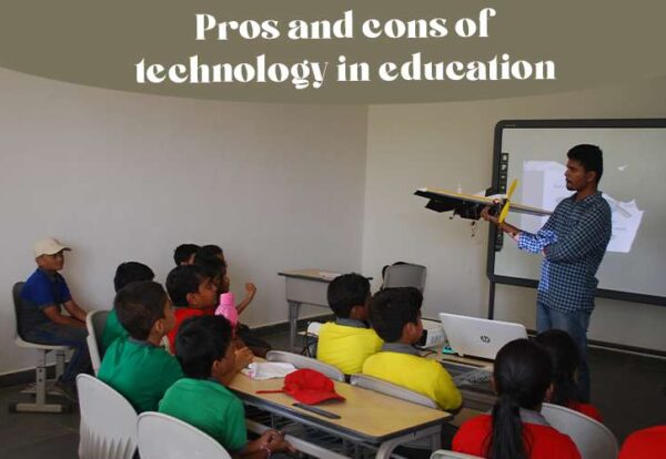 A teacher teaching a class of children explaining the pros and cons of technology in education