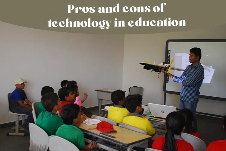 A teacher teaching a class of children explaining the pros and cons of technology in education