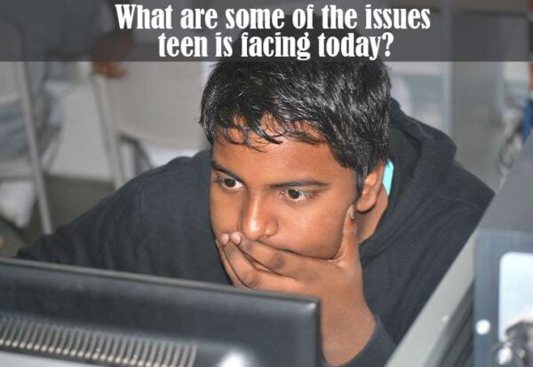A teenager preoccupied with using computer, highlighting technology addiction, one of the issues teens are facing today.