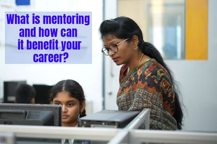 A teacher mentoring a child while looking at a computer.