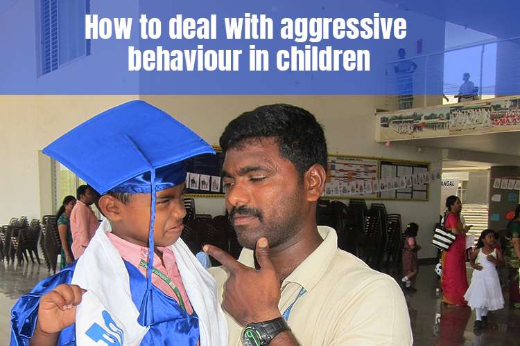 A person and child in a graduation cap dealing with the aggressive behaviour of the child