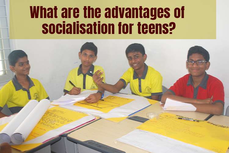 A group of young boys sitting at a table, engaging in socialisation.