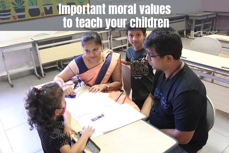 A woman and man sit at a table with two children, engaged in discussion about important moral values
