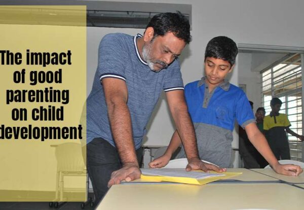 A man and a young boy examining a document together on a table in a classroom setting, with text overlay about parenting and child development.