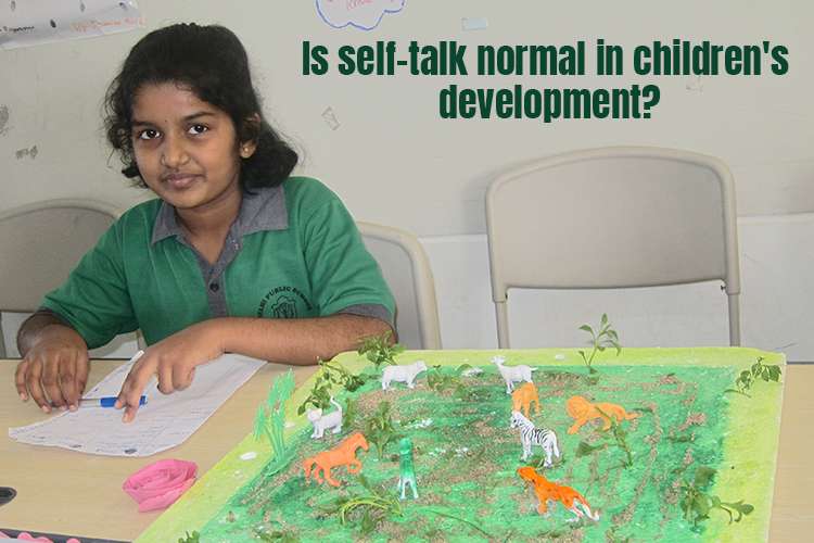 A young child sitting at a table with a model of animals doing a self-talk